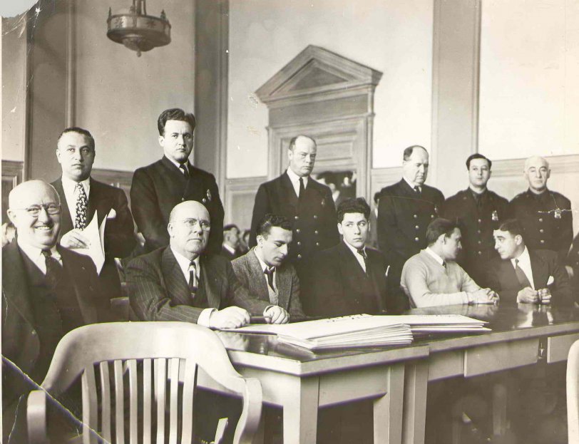 My great grandfather Leo Healy (sitting second from left with hands on table) with his clients, two boys accused of murder in a 1930's Brooklyn courtroom.  Both boys were found not guilty.